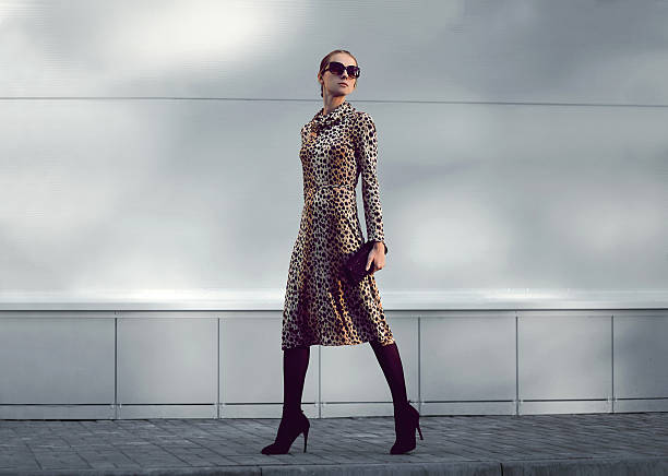 Woman confidently walks in a bold patterned dress, demonstrating how to style bold prints effectively.