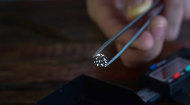 Examining diamond with flashlight to gauge authenticity